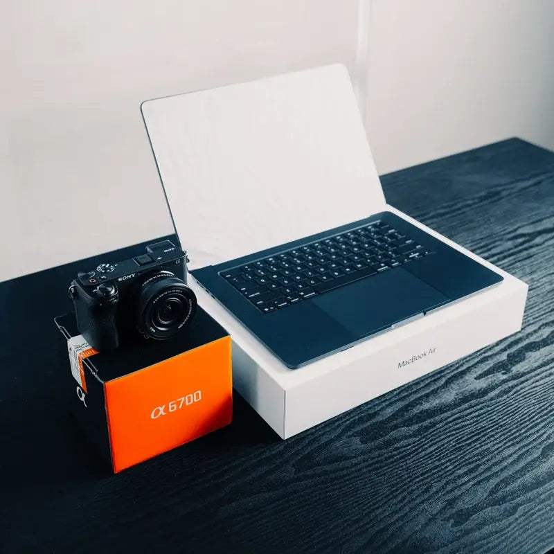 Sony A6700 with kit lens and a MacBook Air