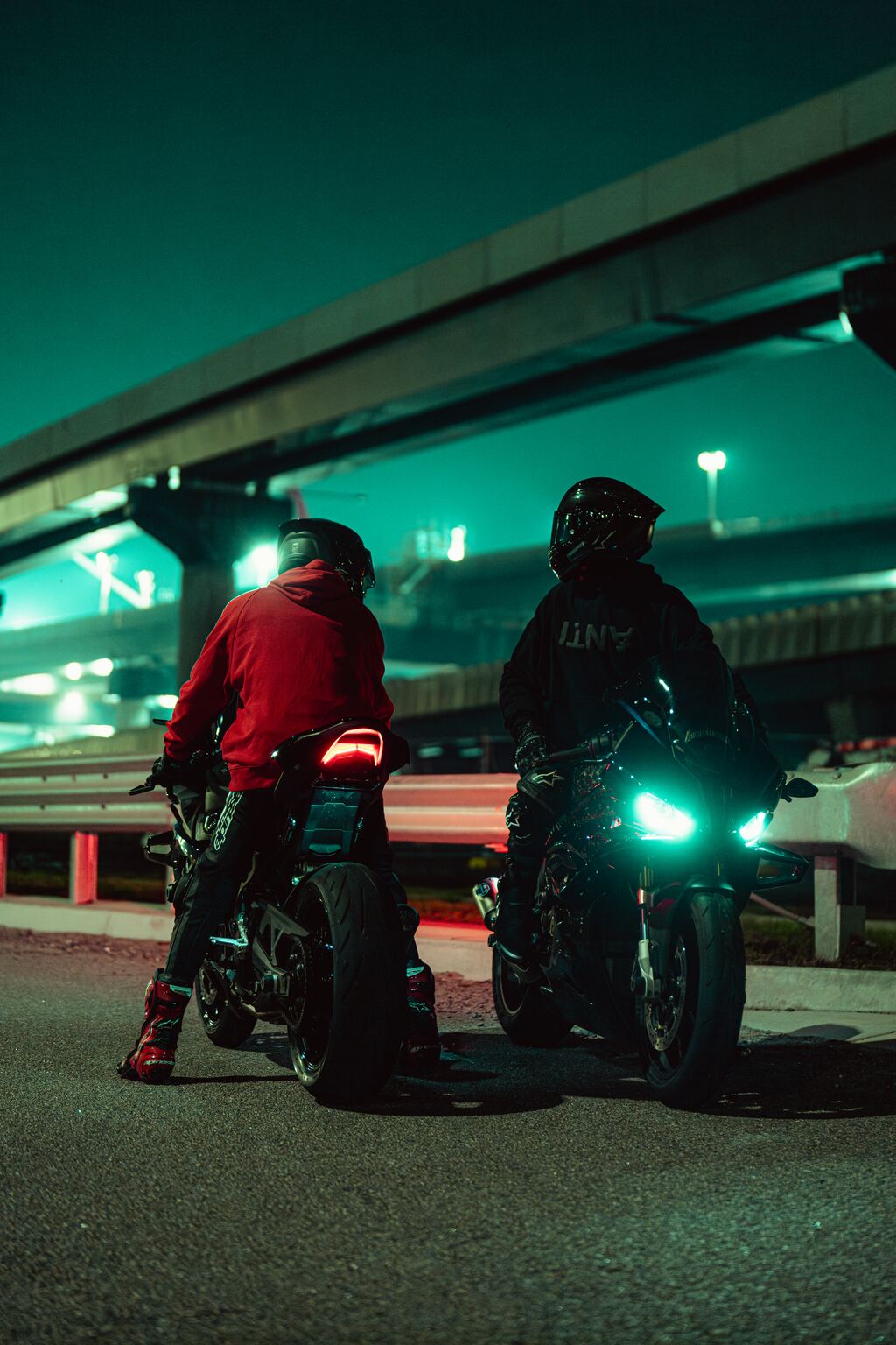 Two riders under an overpass at night, edited with North Borders presets