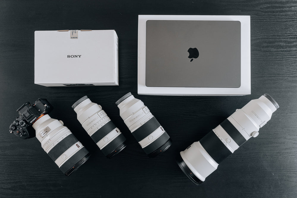 Sony A7R VI with telephoto lens and MacBook Pro
